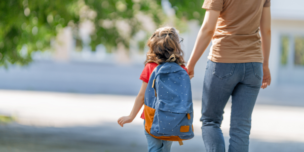 kid and parent walking to school